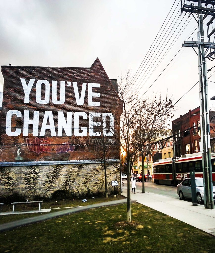 Side of building with "You've changed" painted in large letters
