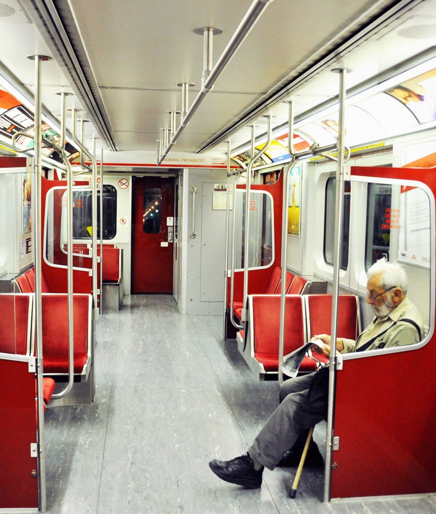 Man sitting in an empty subway car